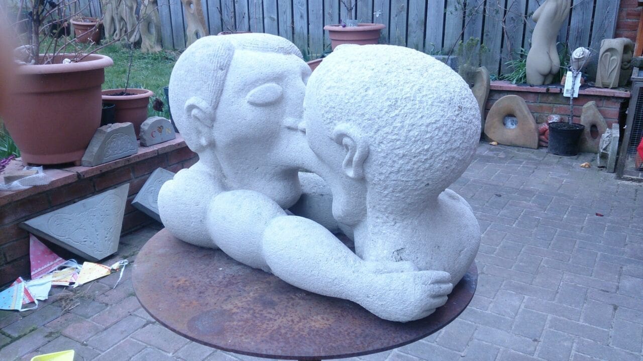 Kissing Cousins (Symbolic Men Kissing Stone statue)