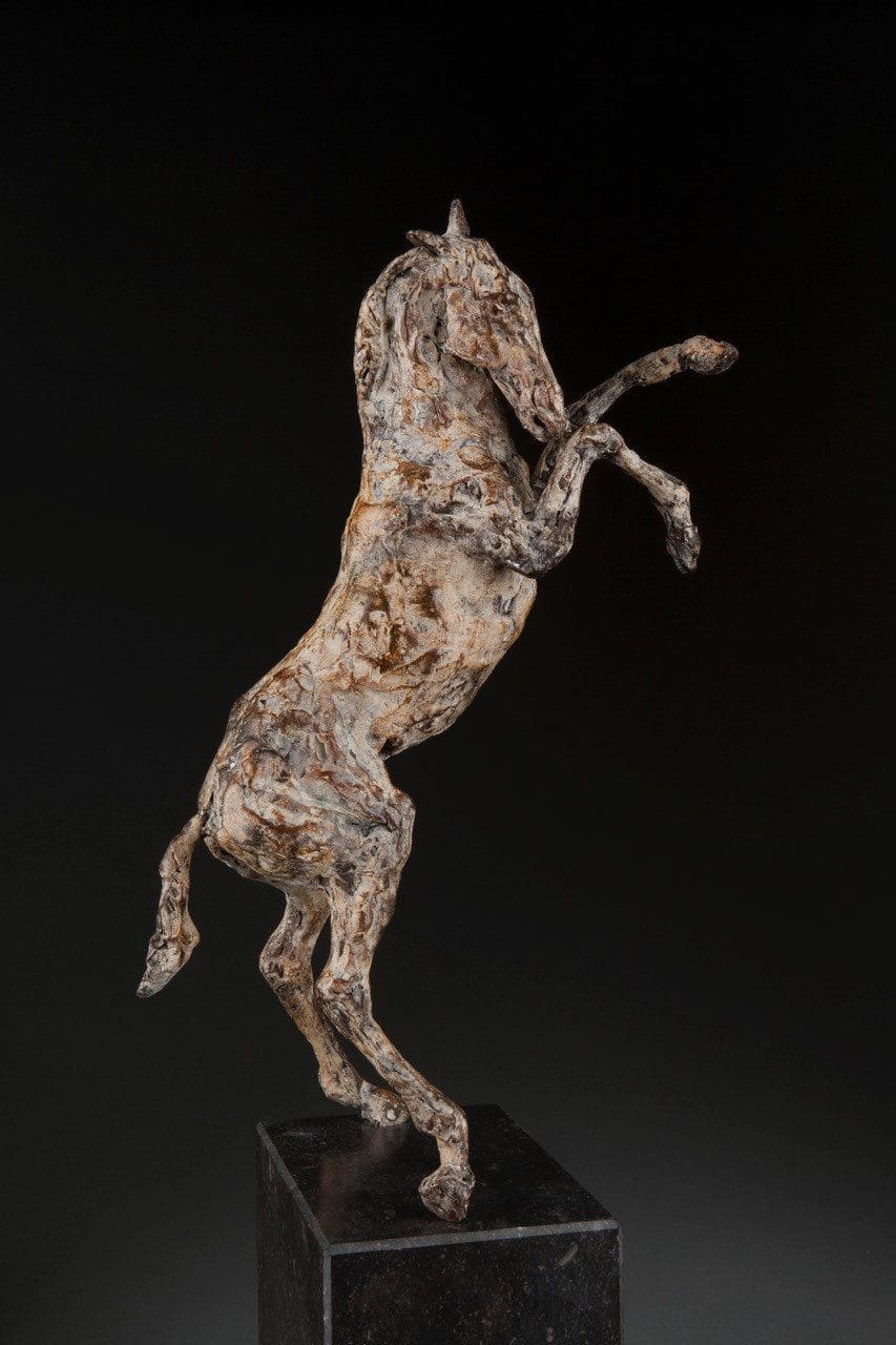 Bronze rearing horse sculpture on stone base by Ans Zondag