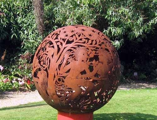 Large circular marine steel garden sculpture titled Pastoral Dance by Aragorn Dick Reed