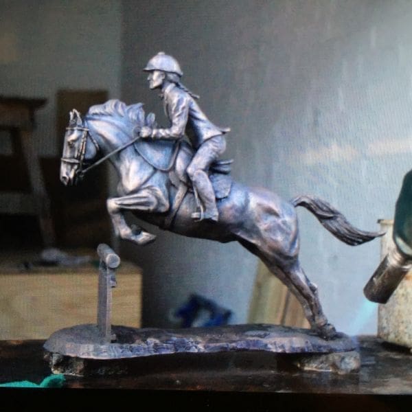 Small bronze jumping horse sculpture by Jenna Gearing