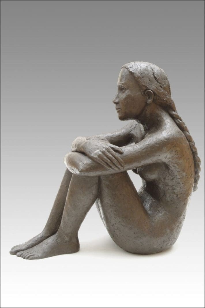Bronze sculpture “Kate” by Jenny Wynne Jones, portraying a seated girl in contemplative pose.
