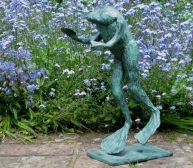 Bronze sculpture of a frog reading a book by Lynda Hukins.