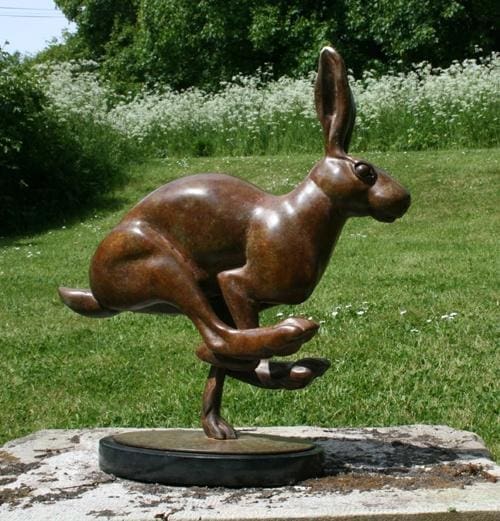 Bronze sculpture of a running hare in full motion by Martin Hayward-Harris
