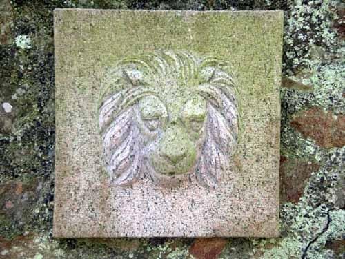 Granite lion head fountain sculpture by Moudoir Moudoir, designed as a classical wall-mounted water feature.