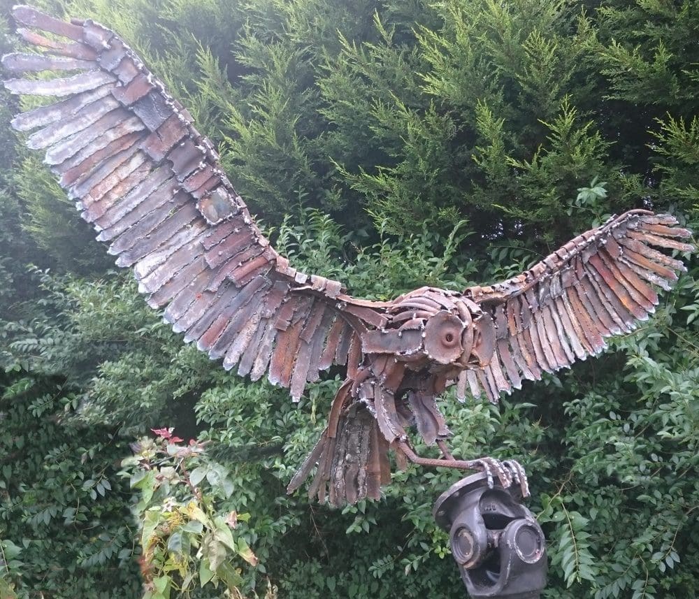 Large recycled steel owl landing sculpture by Myles Mansfield