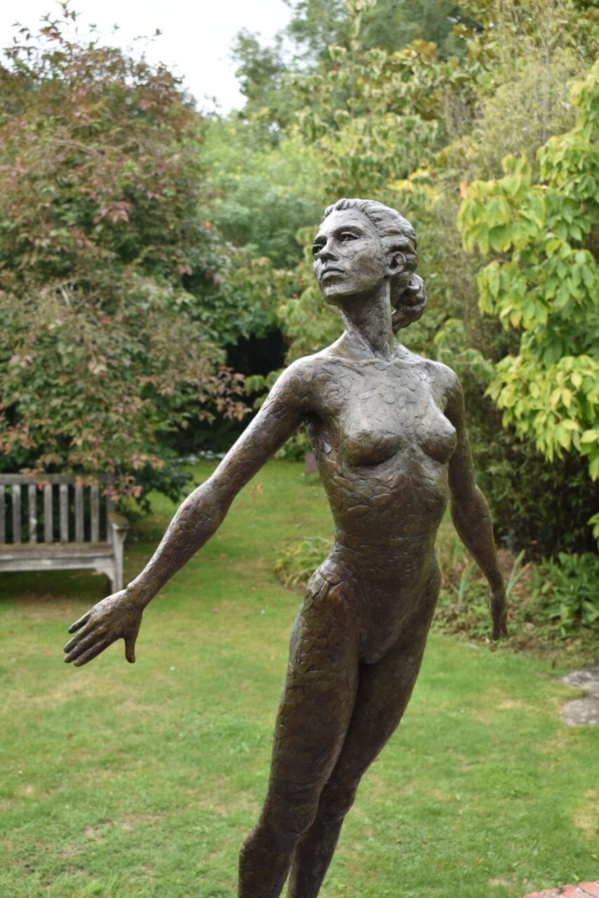 Bronze sculpture of a diving female figure titled Chiara by Nicola Godden