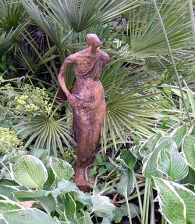 Cold cast iron sculpture of a walking female figure by Pam Foley