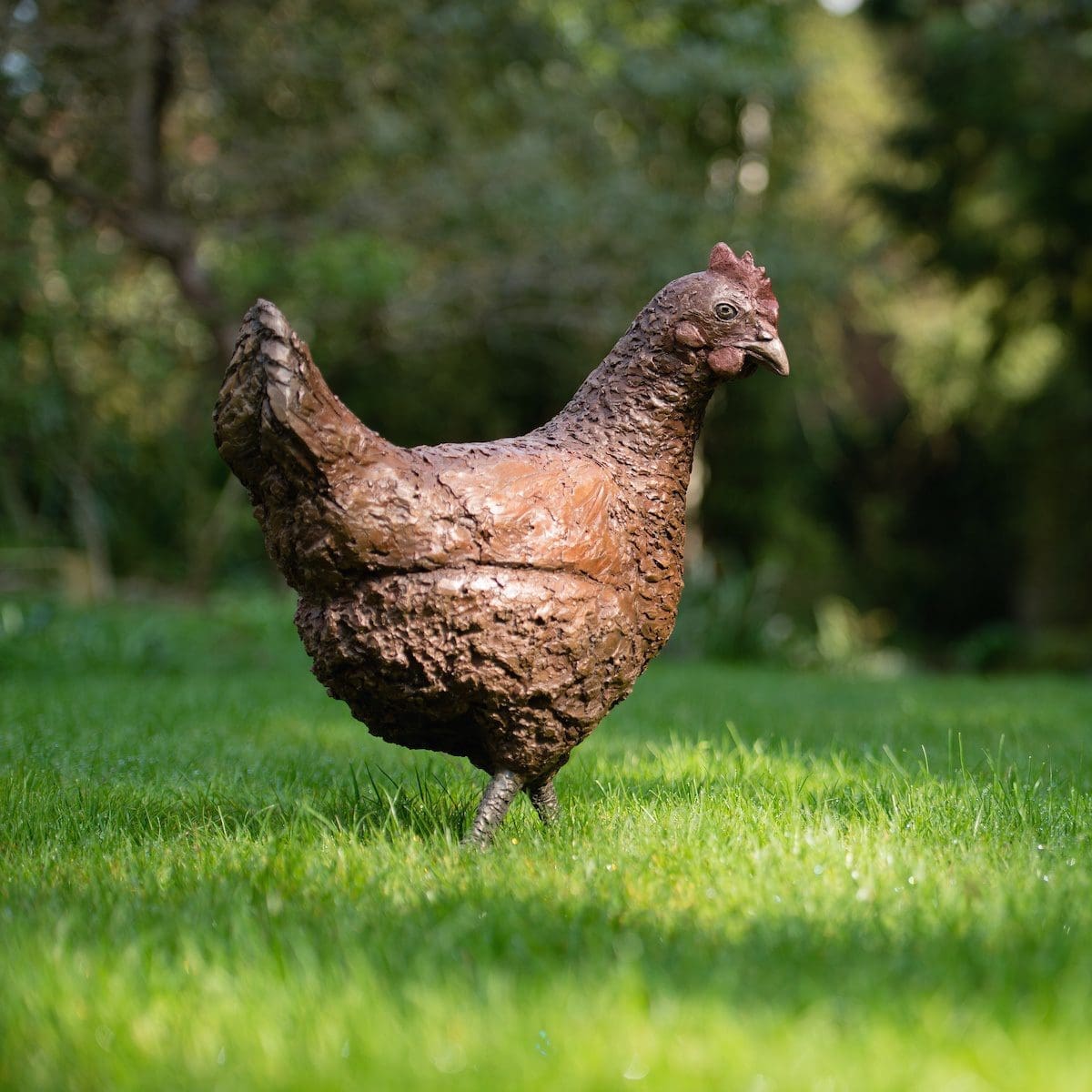 Life-size bronze hen sculpture by Marie Shepherd showing a red hen standing with natural posture and detail.