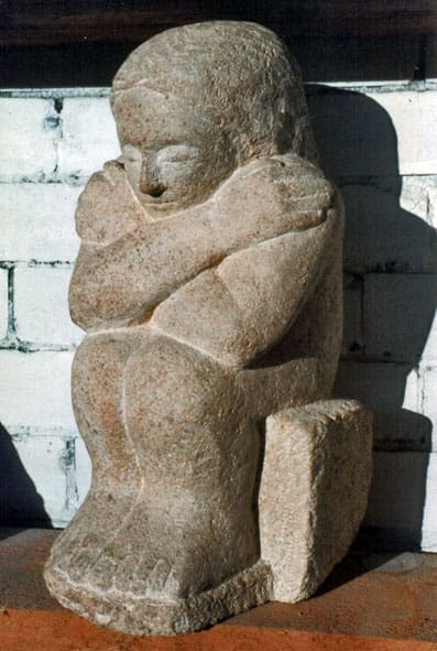 Stone sculpture “Grief” by Vega Bermejo Castlenau, depicting a child in sorrow, hand-carved with emotional depth.
