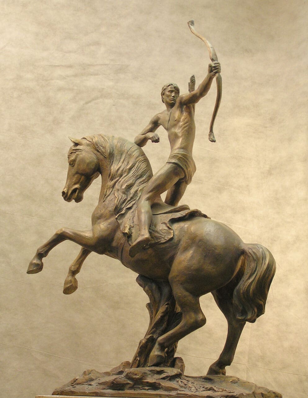 Bronze and stone sculpture of a mounted nude warrior bowman on horseback by Boldyrev Gennadi