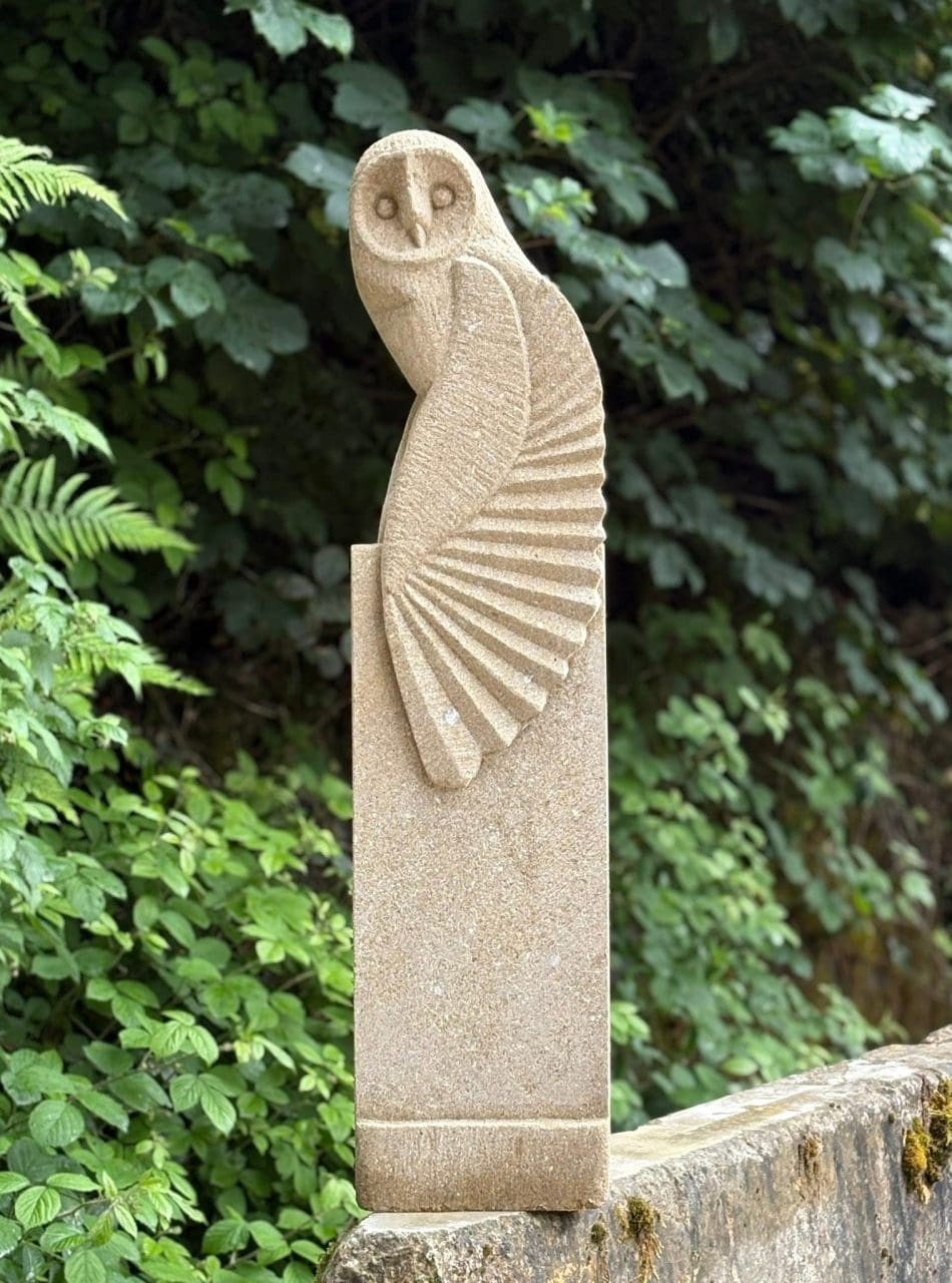 Tall carved sandstone barn owl sculpture by Stephen Nicholson