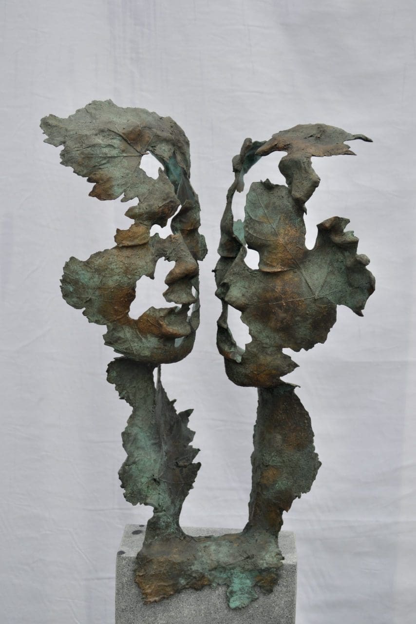 Bronze figurative sculpture by Hans Koenen depicting an intimate embrace between two figures.