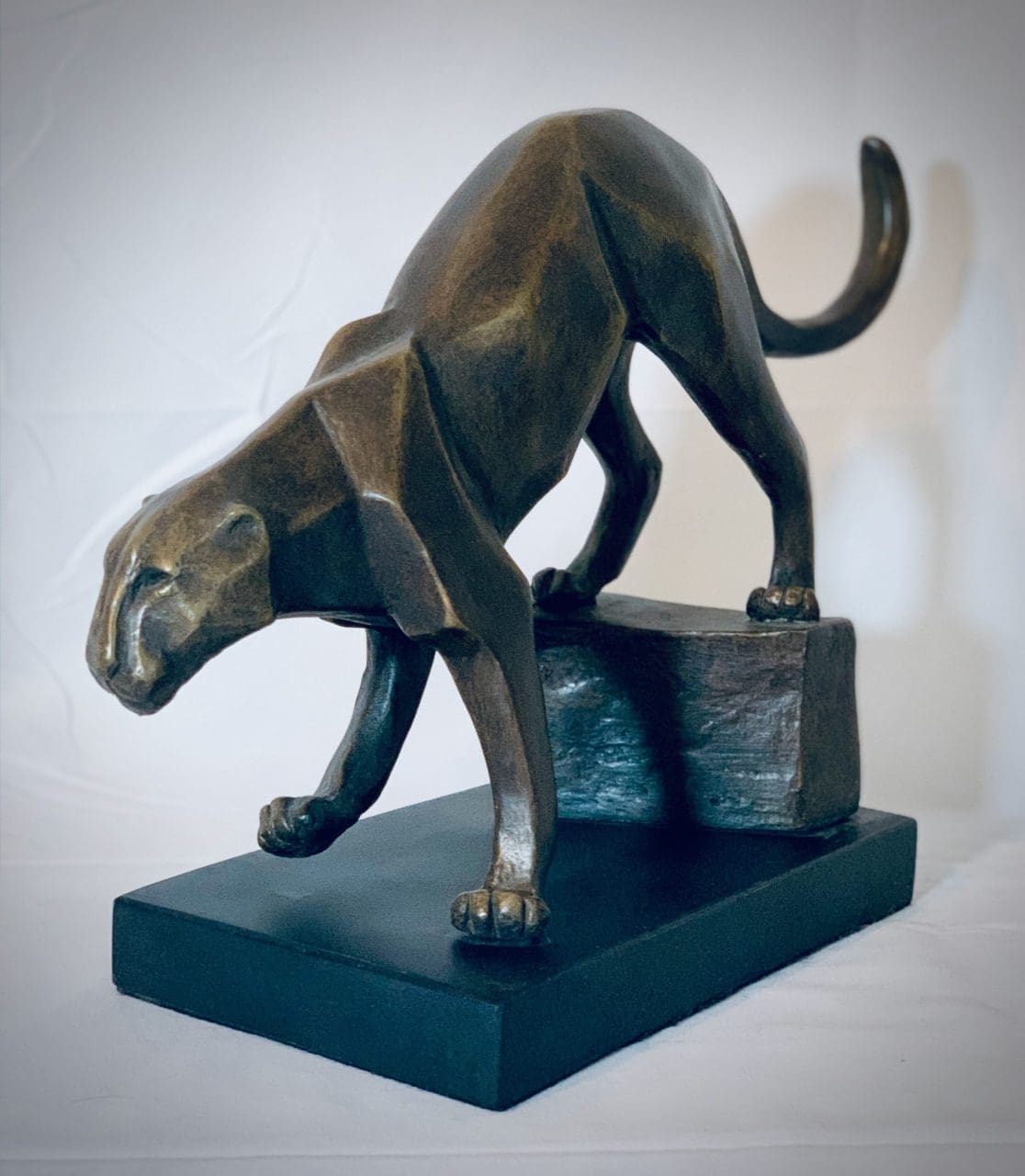 Contemporary wildlife sculpture of a stalking predator by Marie Ackers in acrylic resin, capturing stealth, focus and movement.