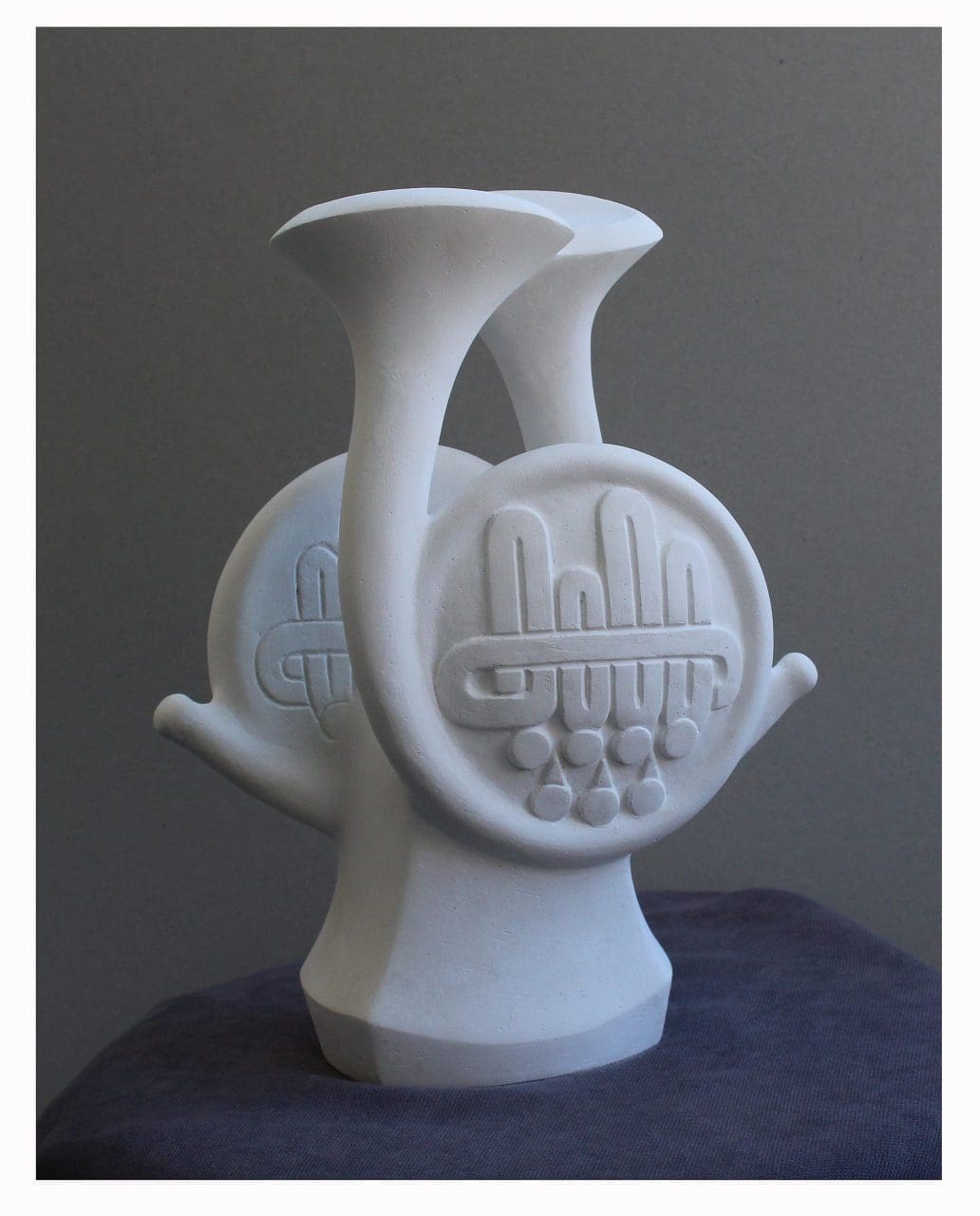 Abstract marble sculpture inspired by a French horn by Irodi Gvelesiani