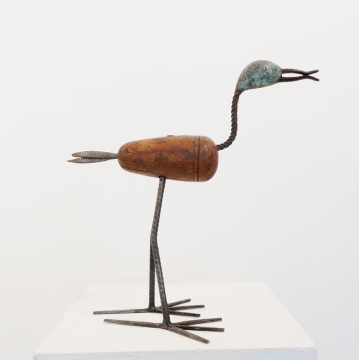 Handcrafted bird sculpture by Lawrie Simonson made from apple wood and metal.